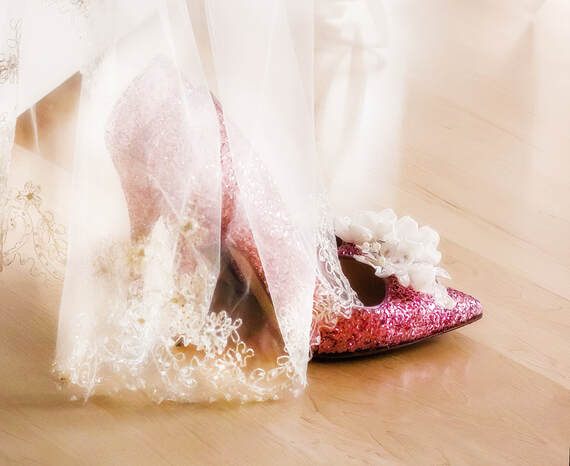 a sparkling pair of pink shoes with a veil