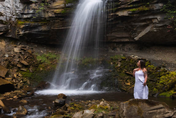 a girl gazes at a waterfall