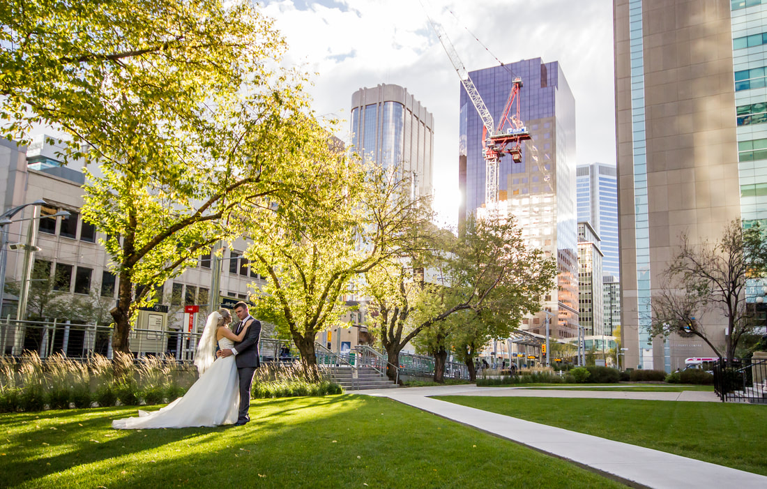 a married couple pose in a park in downtown calgary