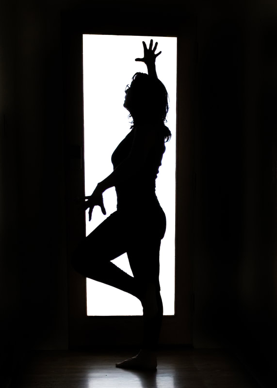 Silhouetted image of a woman posing in black and white